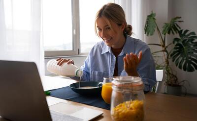 Woman having a videocall while eating