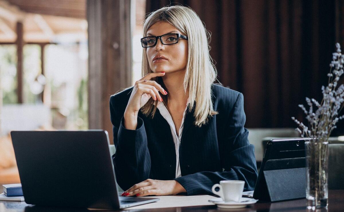 Young business woman working on computer in a cafe