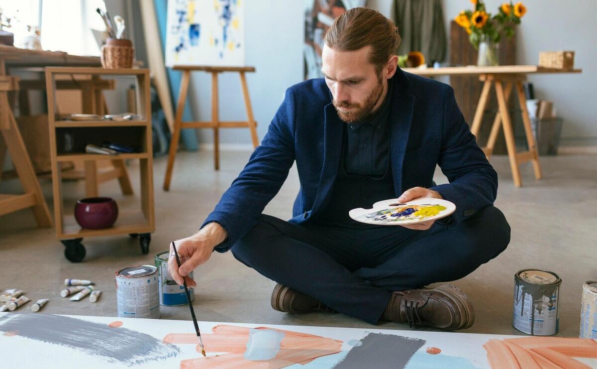 Portrait of handsome bearded man in an art studio