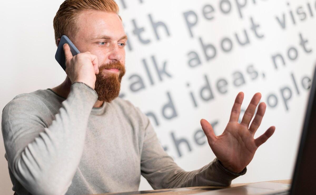 Bearded man talking on the phone
