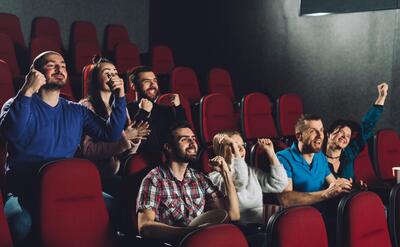 People cheering in cinema auditorium