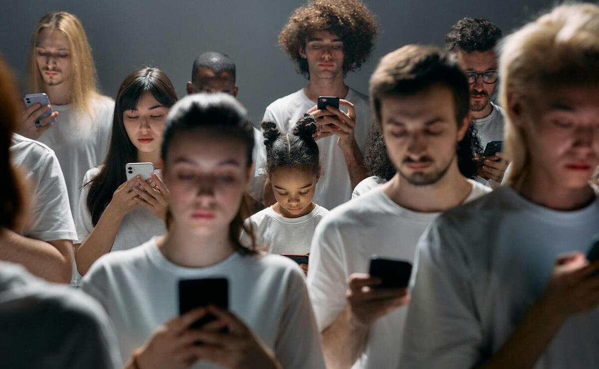 A diverse group of people engrossed in their smartphones, highlighting modern social connectivity.