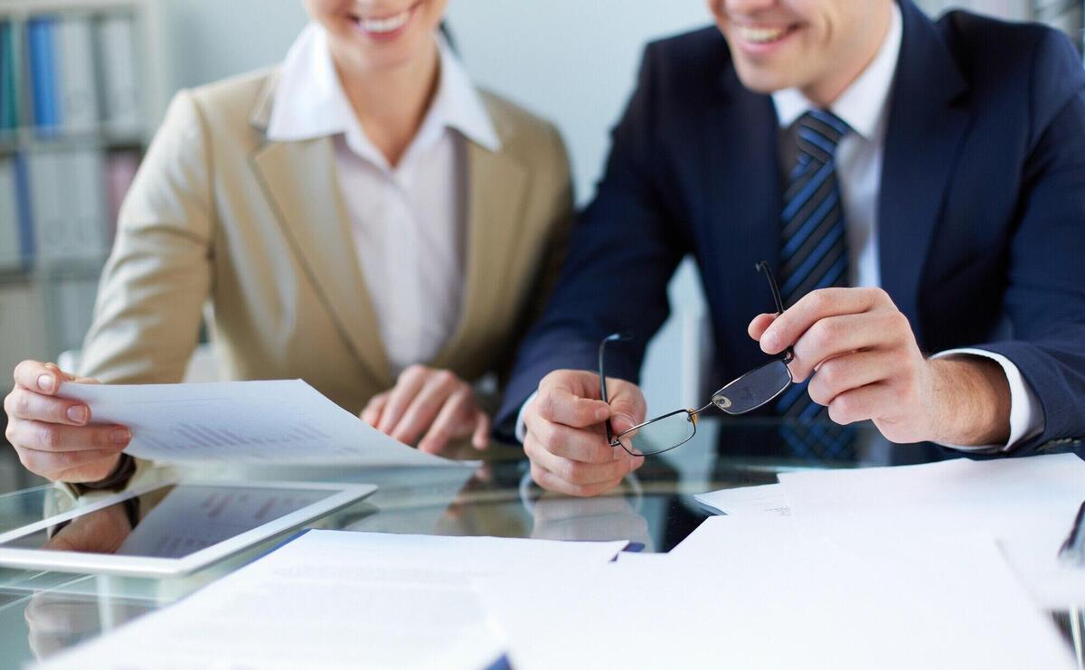 Close-up of businessman holding his glasses