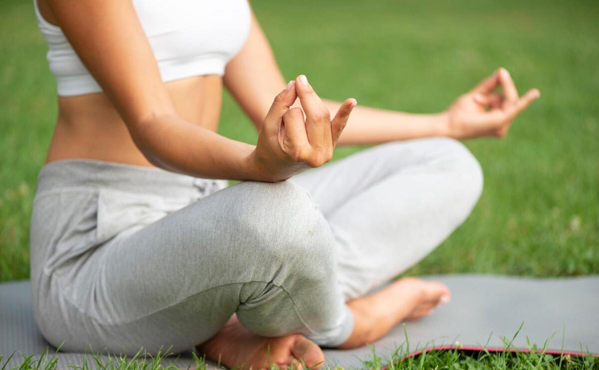 Close-up woman practicing meditation outdoors