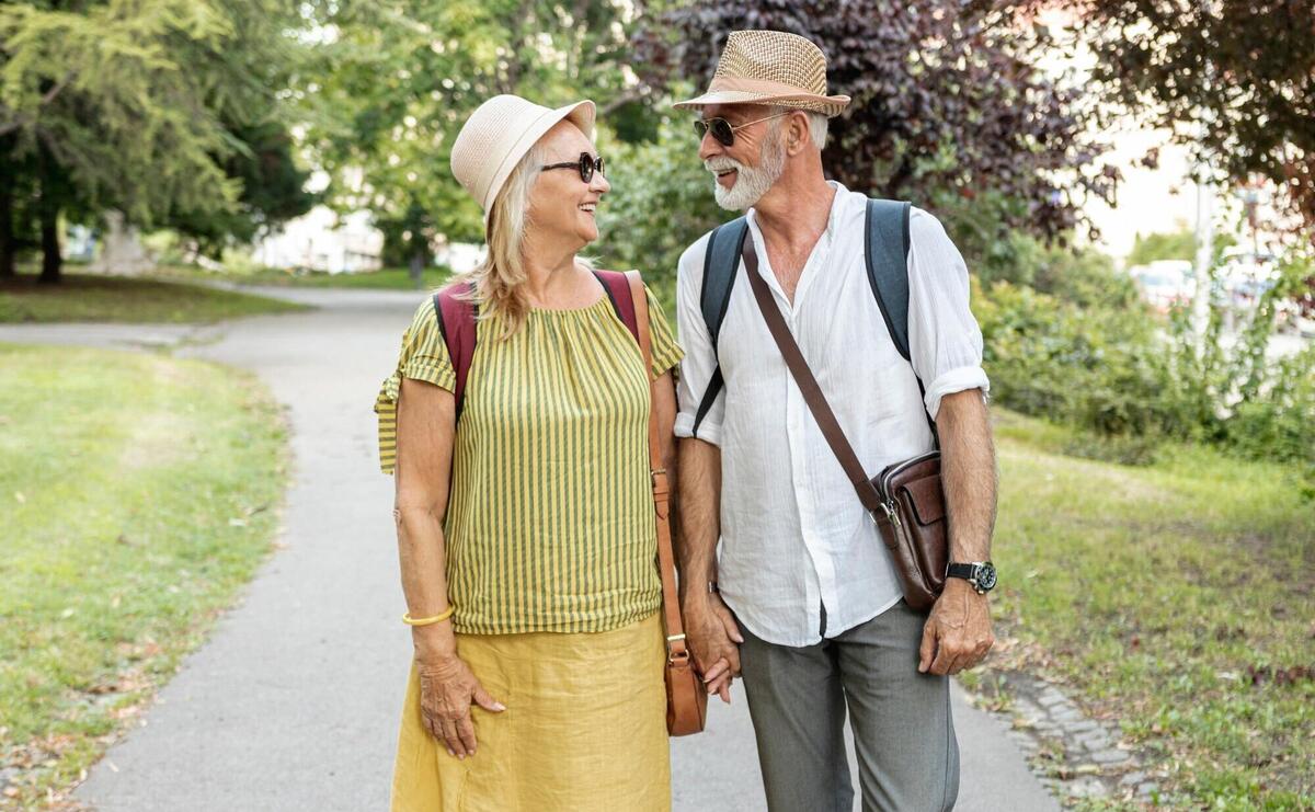 Happy couple holding hands and looking at each other in the park