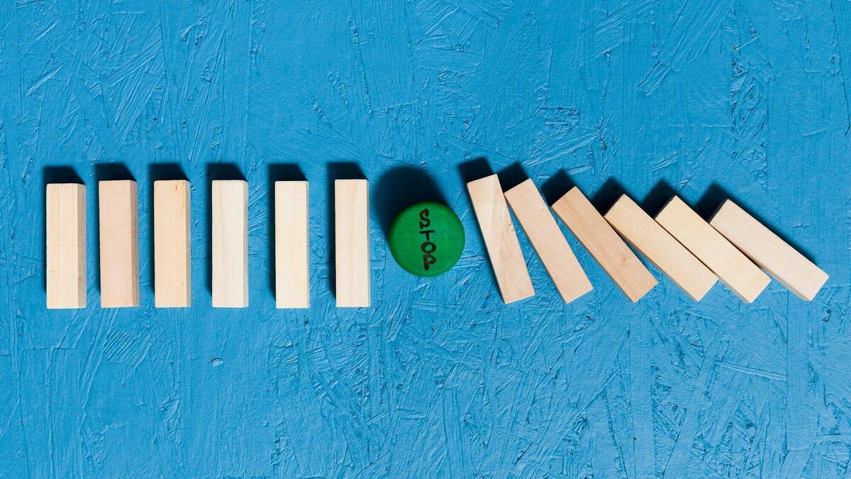 Fallen wooden pieces and green stop sign concept