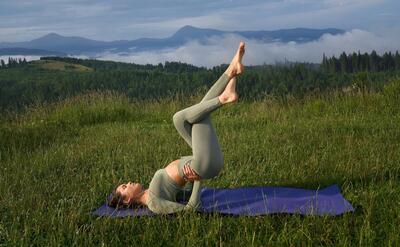 Woman doing fitness exercises with view on mountains