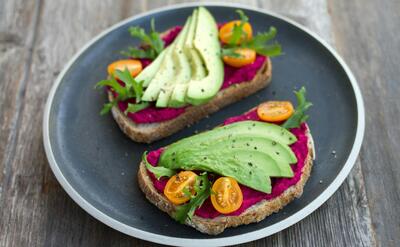 two sliced breads with avocado on top