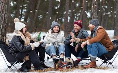 Full shot smiley friends with beer bottles