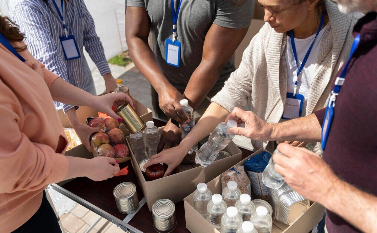 Group of different people volunteering at a foodbank for poor people