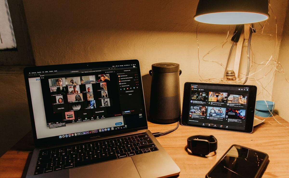 A laptop showing a many people via video chat.