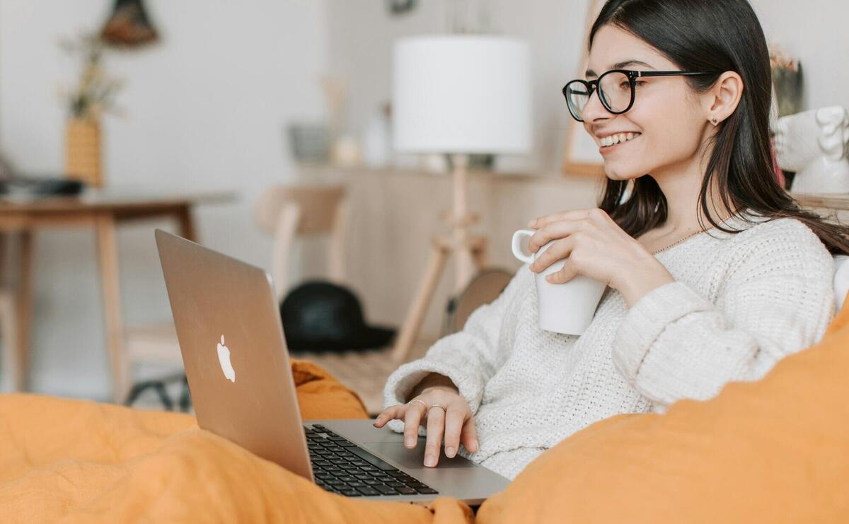 Woman Having Coffee While Using Laptop