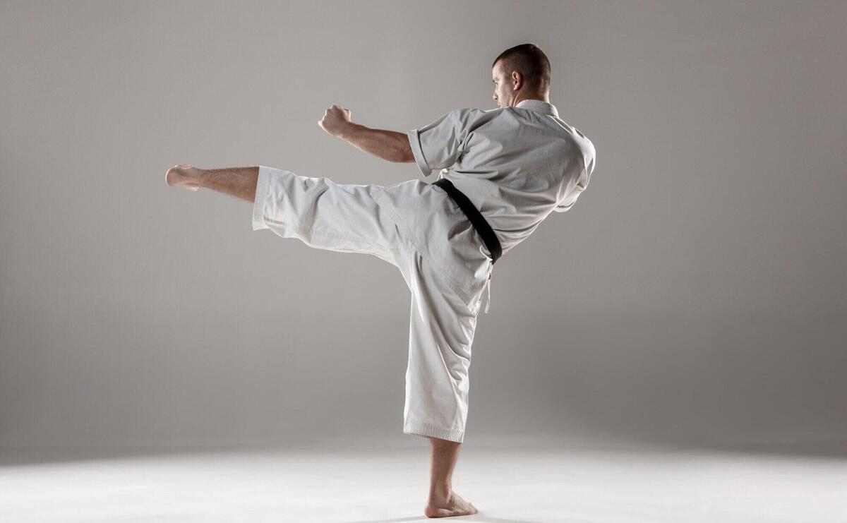 Man in white kimono training karate