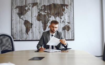 Businessman working in the office.Man reads the contracts. Guy is sitting in the office