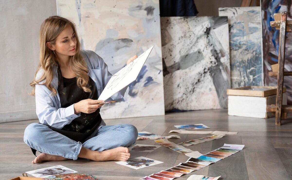 Full shot woman holding canvas