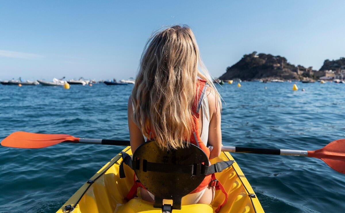 Young beautiful woman traveling by canoe