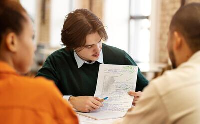 Man studying grammar with his colleagues