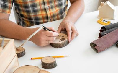 High angle man crafting in wood in workshop