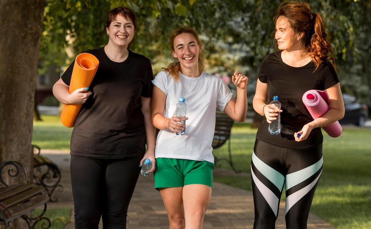 Women in sportswear chatting outside