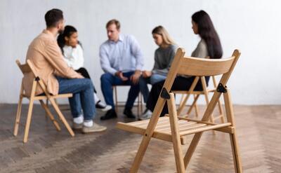 People conversing at a group therapy session