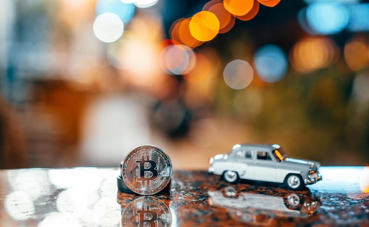 Silver bitcoin and Moskvich 401 on the table, glowing