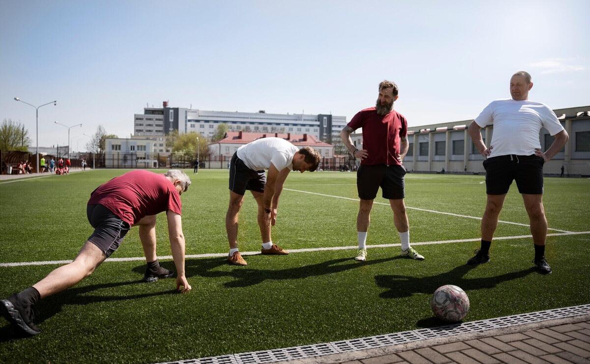 Full shot men stretching before game