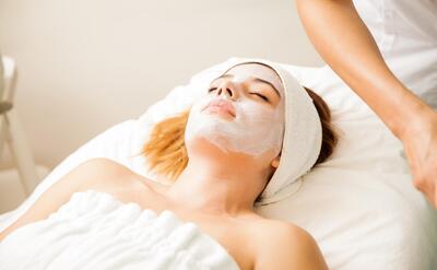 Good looking young woman in the middle of a cellular rejuvenation face treatment at a beauty spa