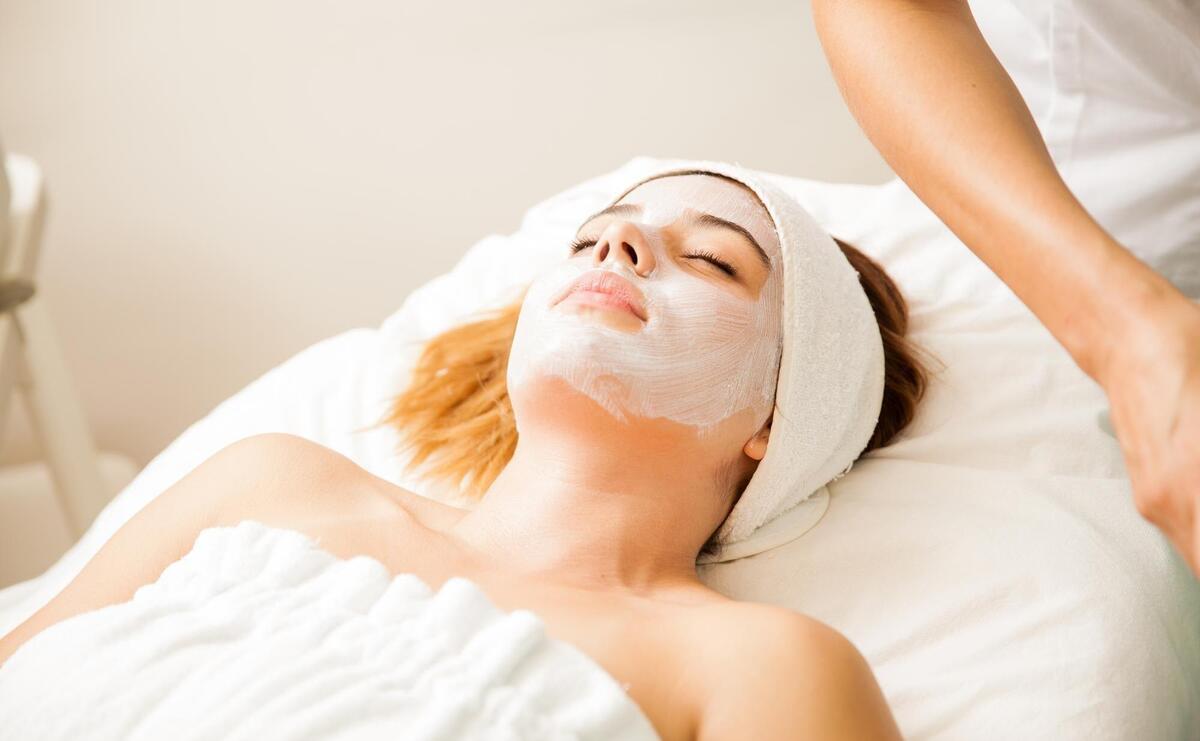 Good looking young woman in the middle of a cellular rejuvenation face treatment at a beauty spa