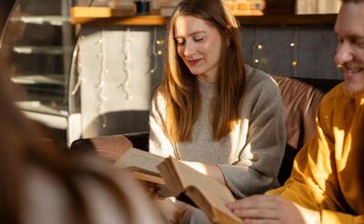 Side view people reading indoors