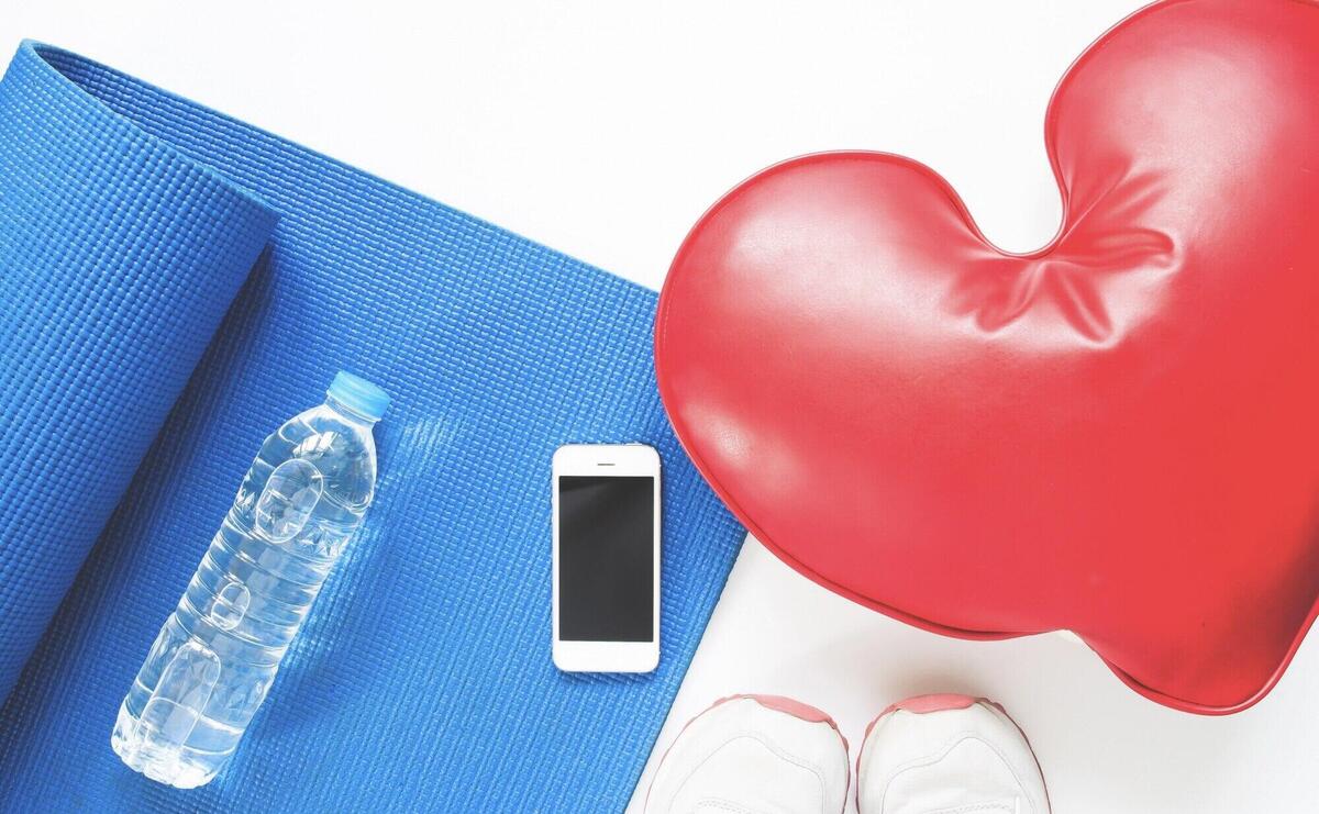 Concept of healthcare with sport equipments on white background with smartphone, Flat lay