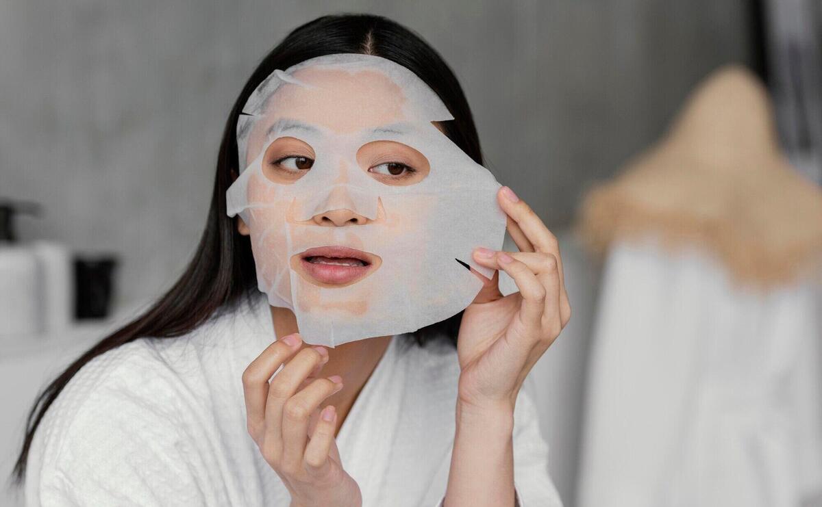 Asian woman using a sheet mask