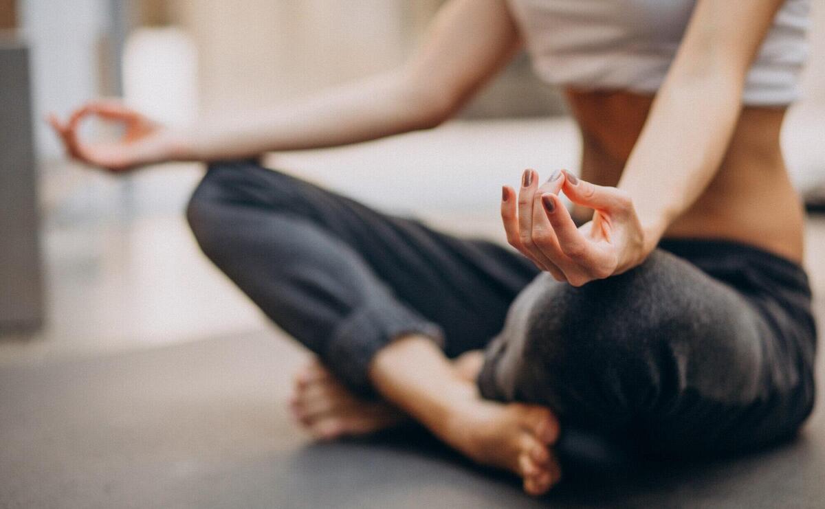 Young woman practicing yoga at home