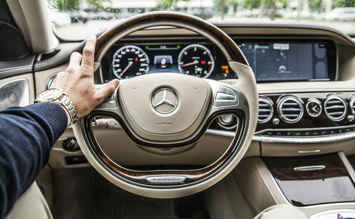 person sitting in Mercedes-Benz driver seat