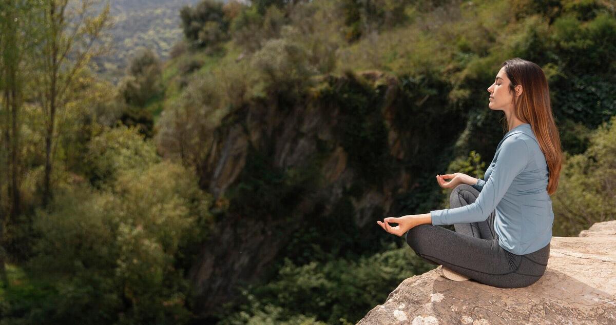 Beautiful woman meditating outdoors