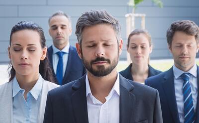 Group of business people with eyes closed