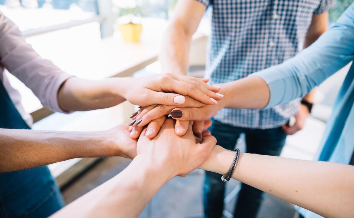 People holding hands together.