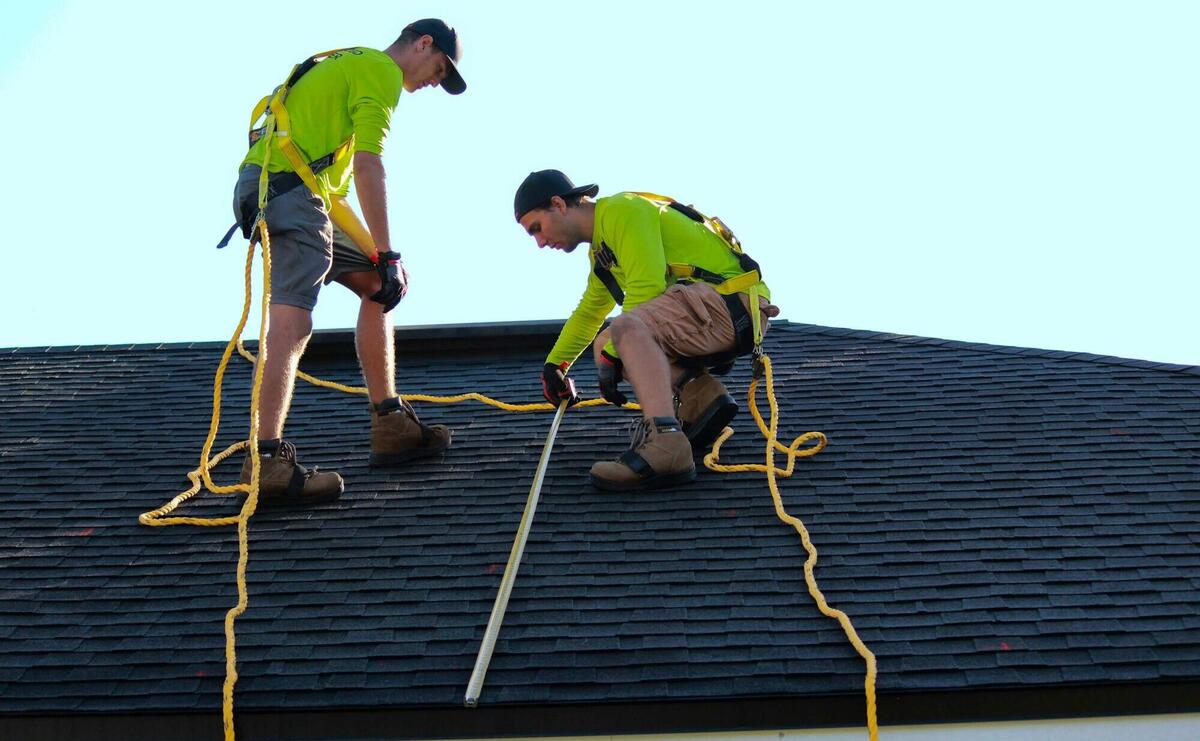 a couple of people that are on a roof