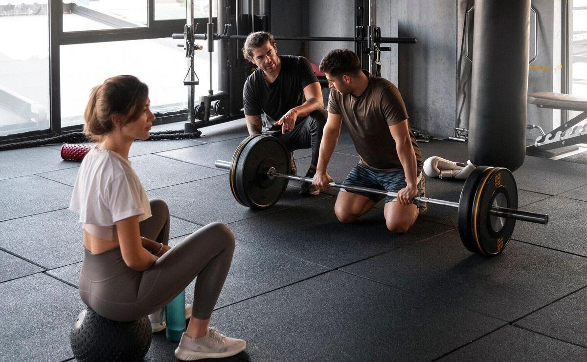 Full shot people training together at gym