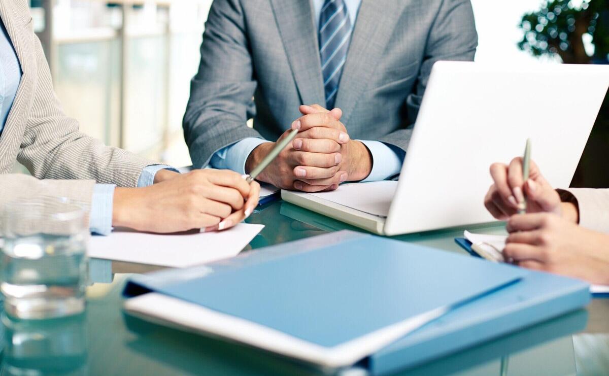 Close-up of executives sitting at the table