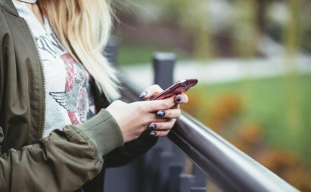 woman holding red phone