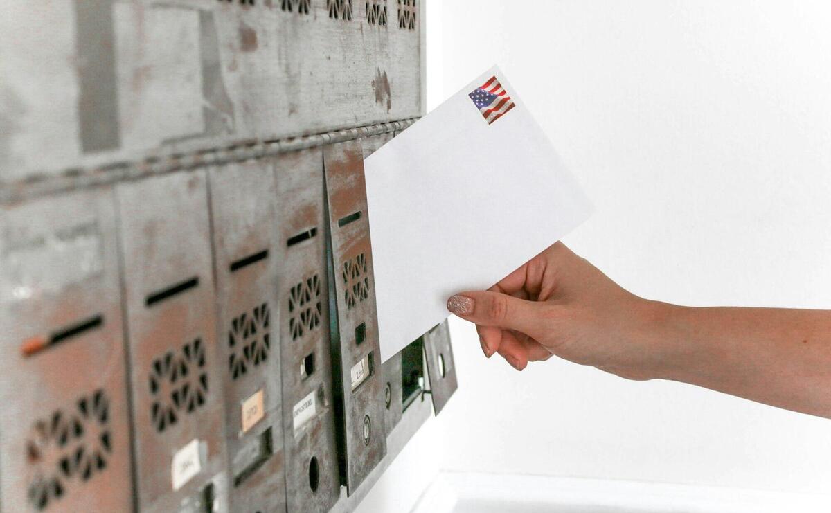 Person Holding White Envelope