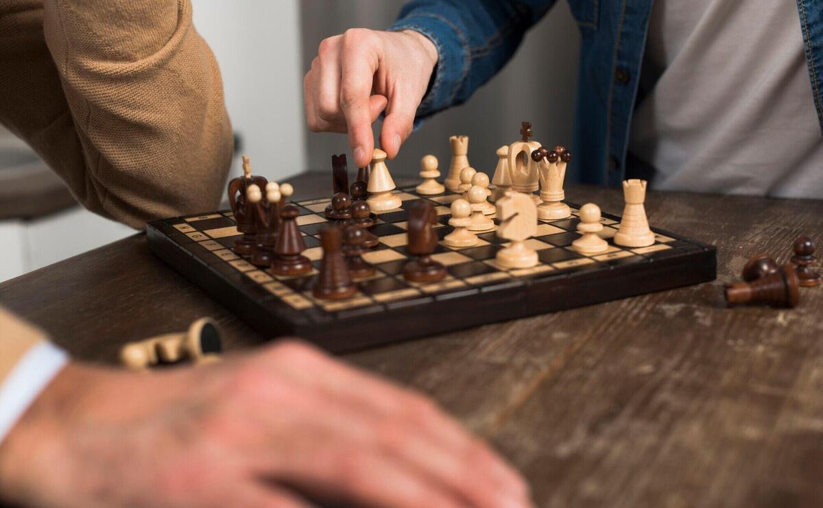 Close-up father and son playing chess