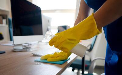 Professional cleaning service person cleaning office