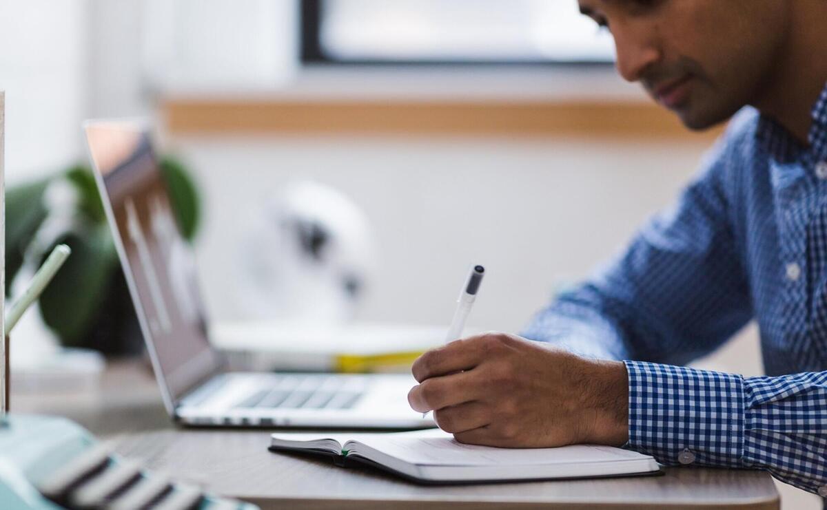 Man, writing, laptop