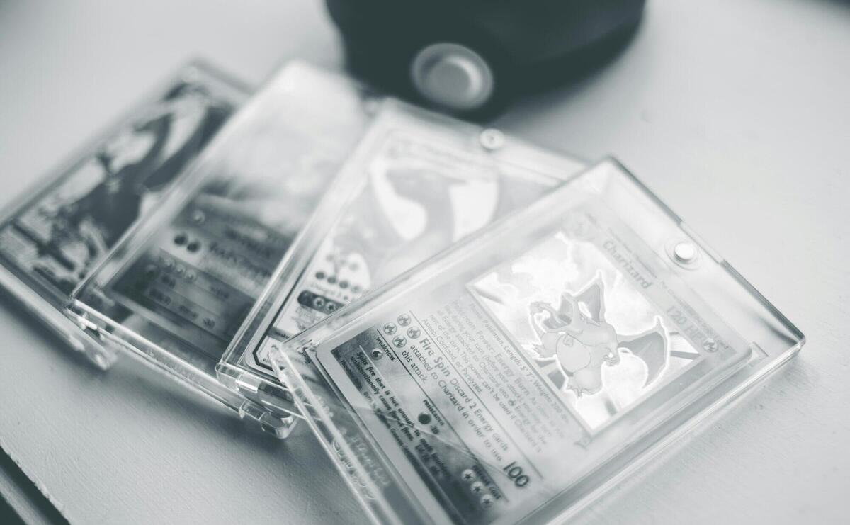 Close-up of collectible Pokemon cards in protective cases, emphasizing preservation and value.