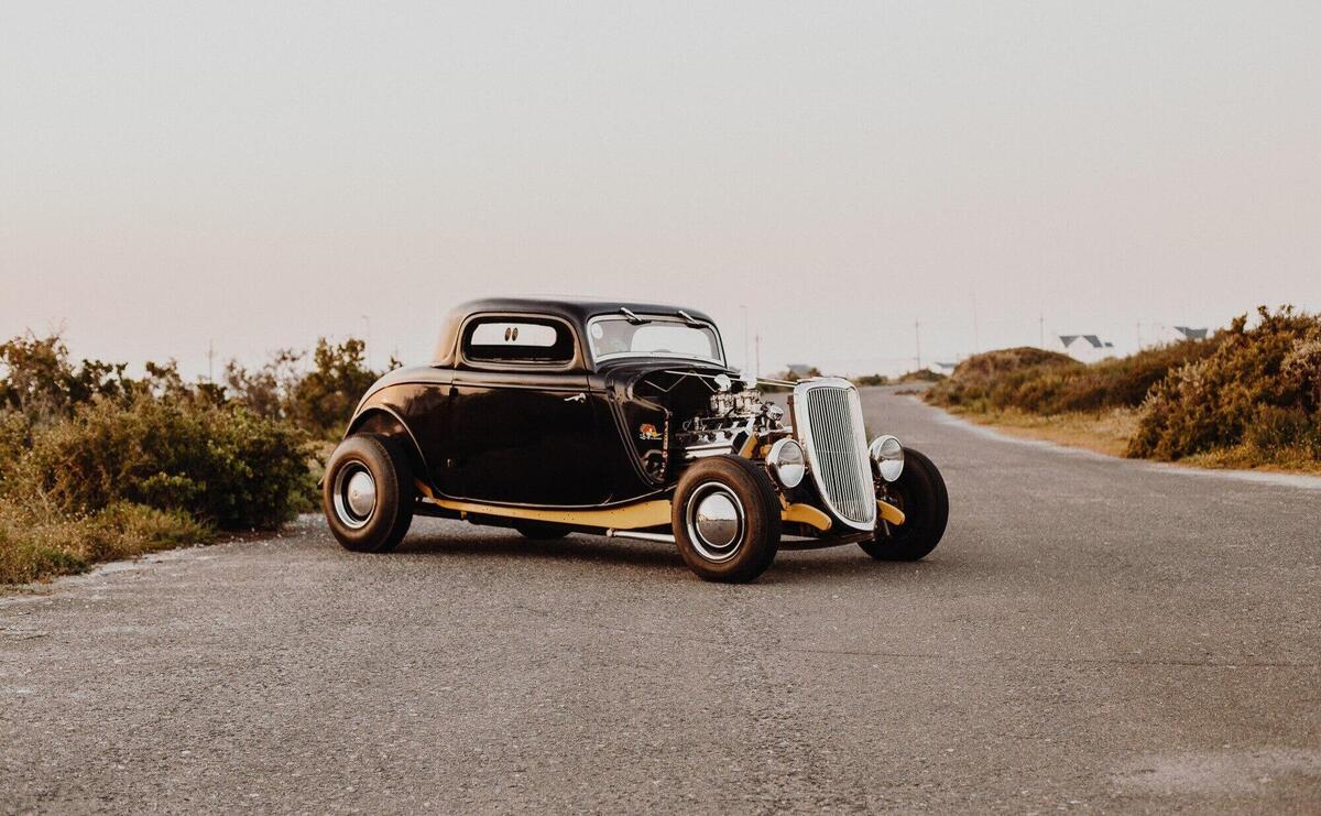 Old vintage car parked in the middle of the freeway road