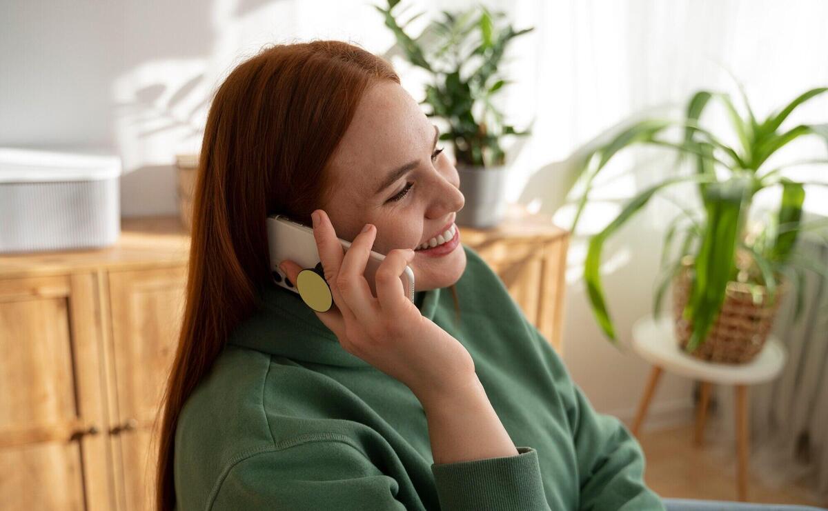 Portrait of woman using smartphone with pop socket outdoors