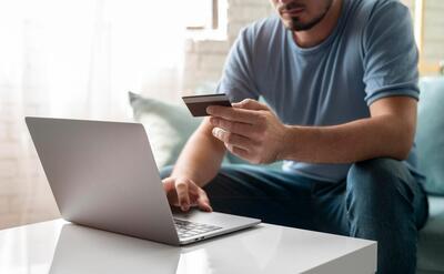 Man using his credit card to play online for an order