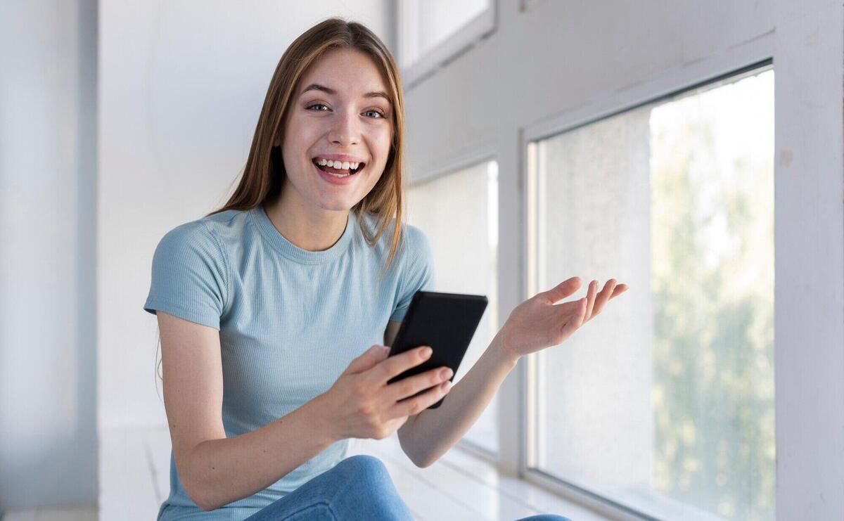 Surprised woman holding her phone