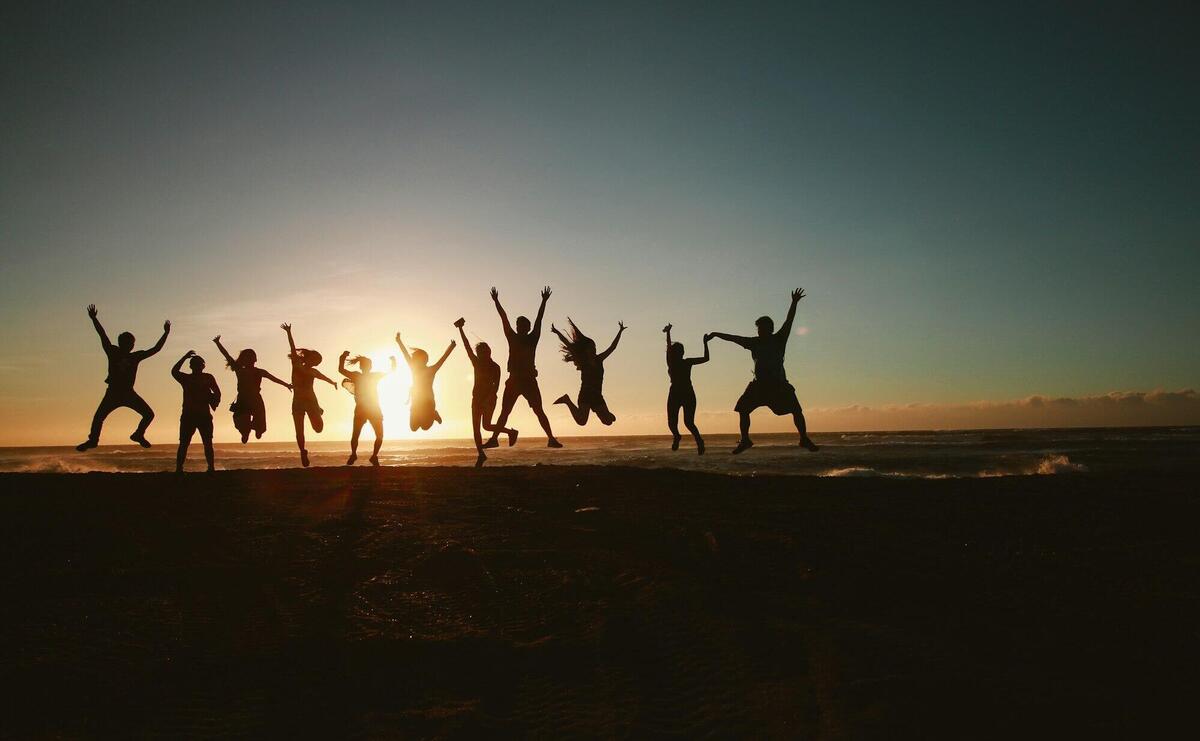 Silhouette Photography of Group of People Jumping during Golden Time